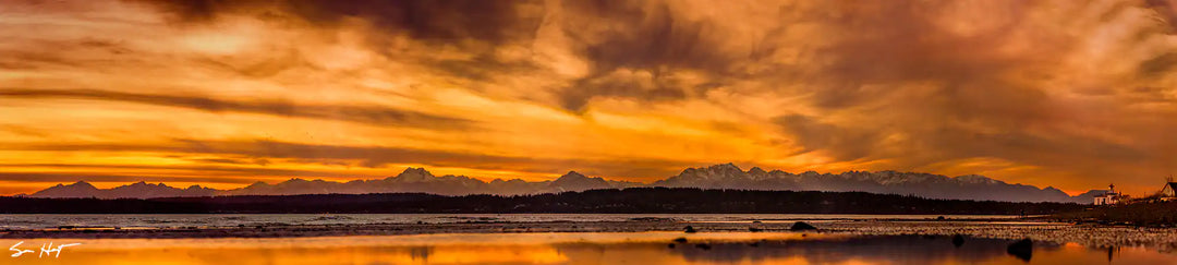 Expansive Olympic Mountains Backlit by Warm Sunset from Discovery Park in Seattle